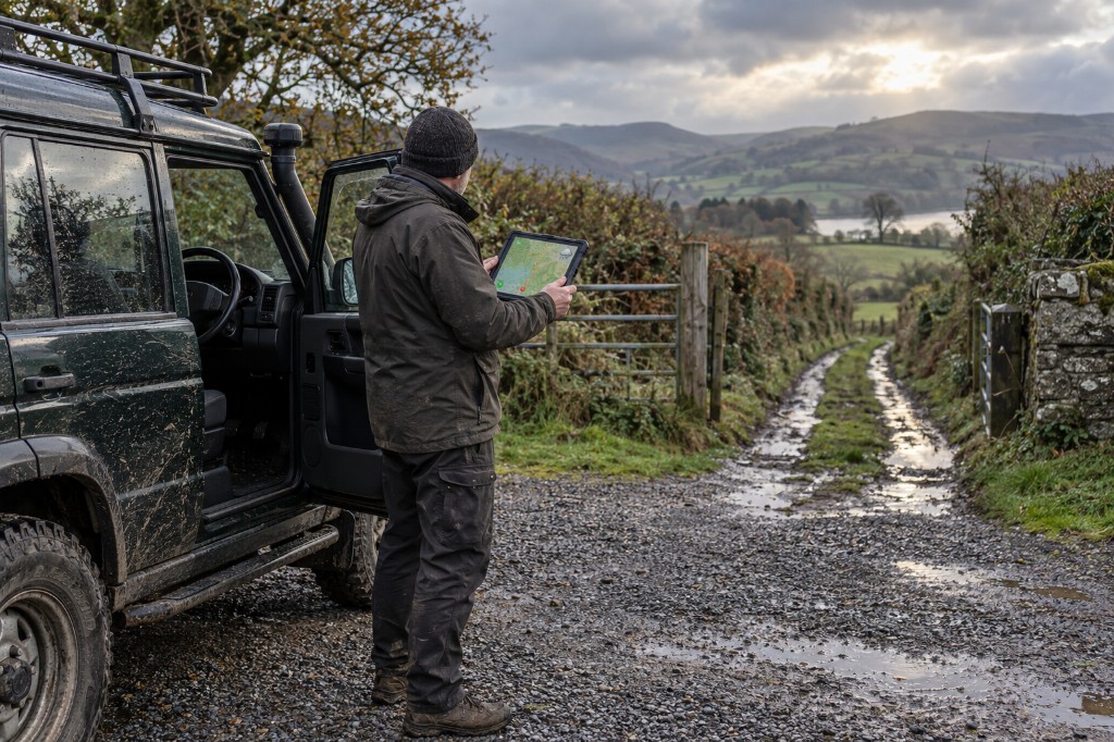 Checking the map on a tablet beside a lane gate
