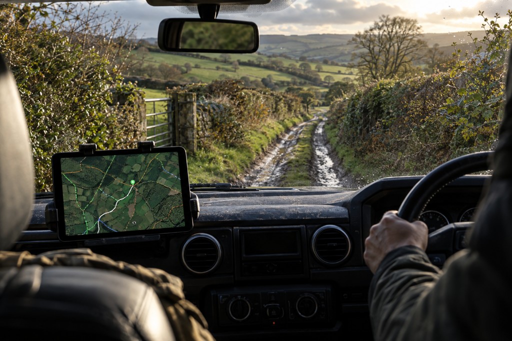 In the cab with the map on a tablet, looking down a green lane